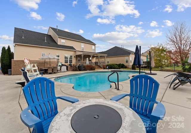 view of pool featuring an outdoor fire pit and a patio area