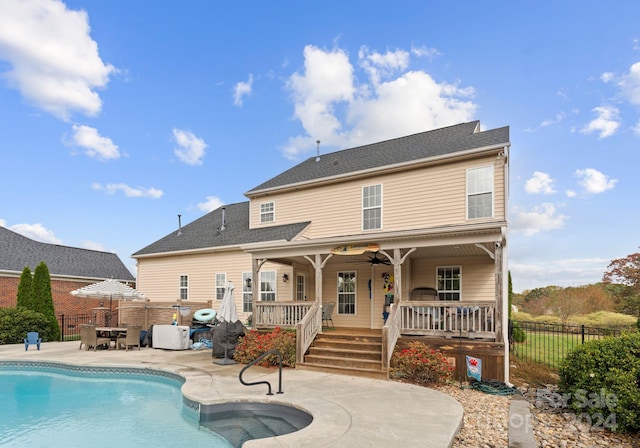 back of house with ceiling fan, a patio area, and a fenced in pool