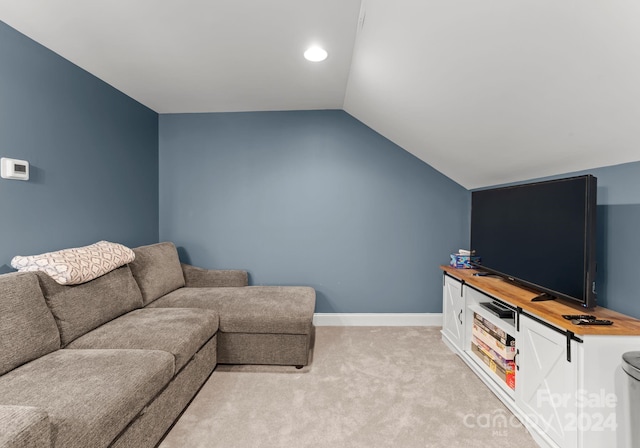 carpeted living room with vaulted ceiling