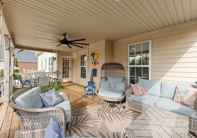 view of patio with outdoor lounge area, ceiling fan, and a deck