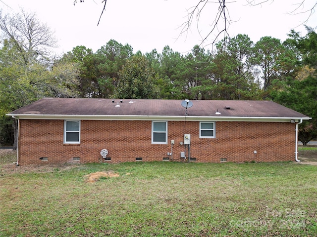 rear view of property with a lawn