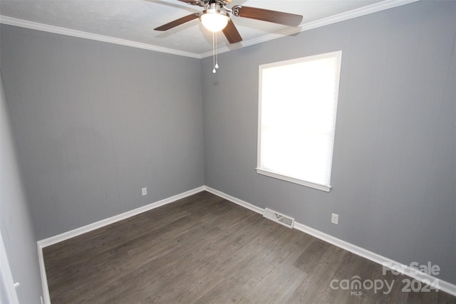 empty room with ceiling fan, dark hardwood / wood-style floors, and crown molding