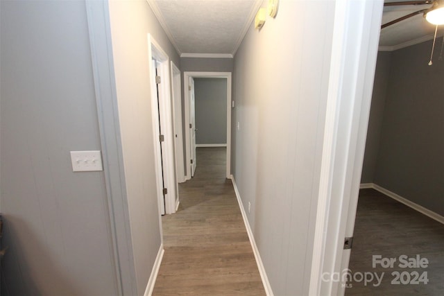 hall with hardwood / wood-style floors and ornamental molding