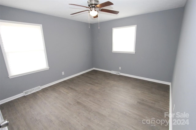 empty room featuring dark hardwood / wood-style floors and ceiling fan