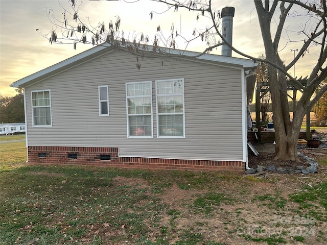 36245 Nugget Rd Unit 2, New London, NC 28127 - property exterior at dusk with crawl space and a yard