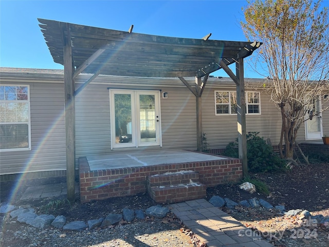 rear view of house featuring a pergola