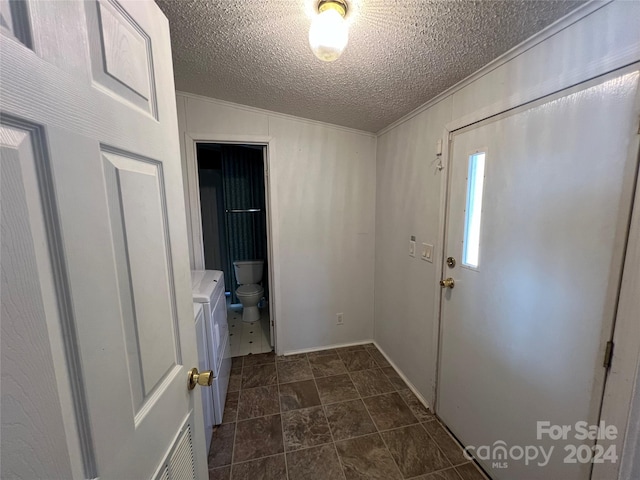 interior space featuring a textured ceiling and crown molding