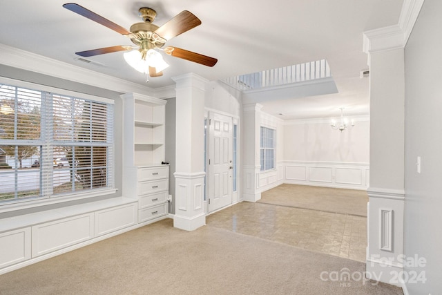 unfurnished bedroom with ornamental molding, light carpet, ornate columns, and ceiling fan with notable chandelier