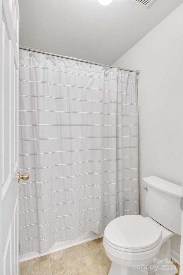 bathroom with tile patterned floors and toilet