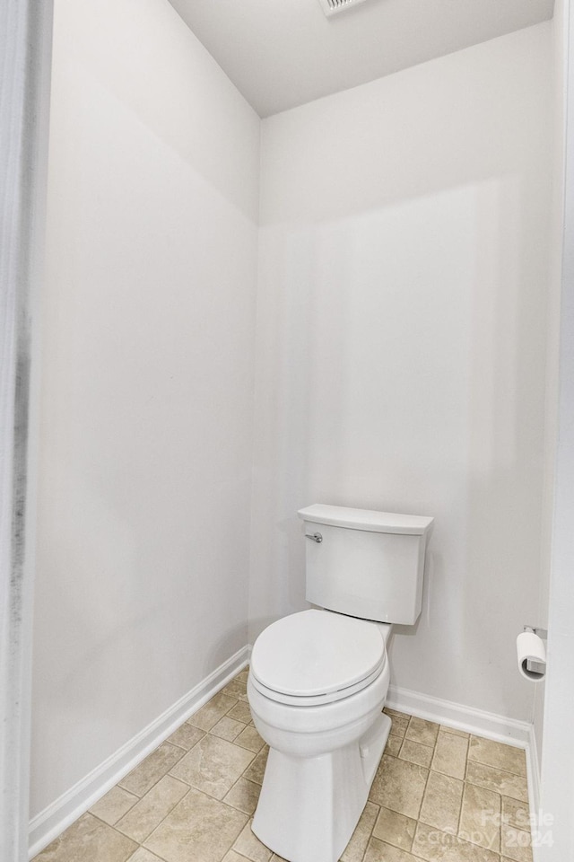 bathroom with tile patterned flooring and toilet