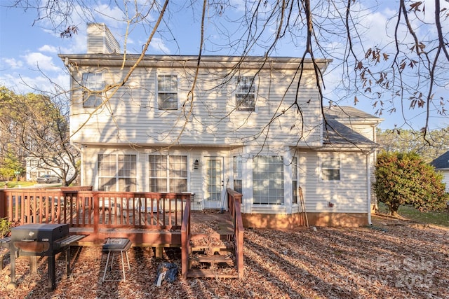 back of property featuring a wooden deck