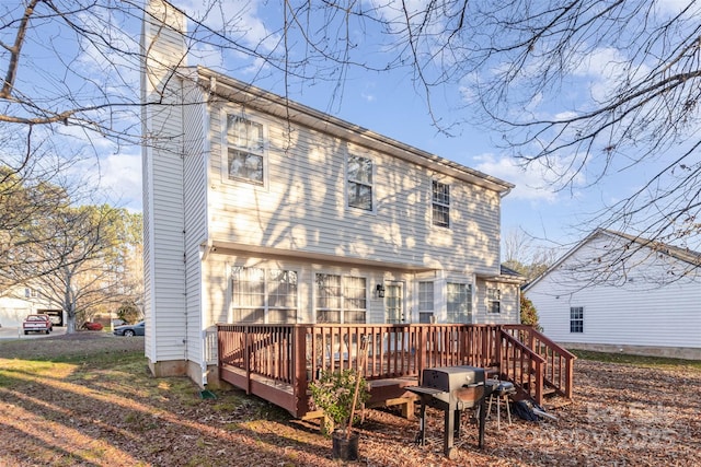 rear view of property with a wooden deck