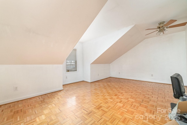 bonus room with ceiling fan, light parquet flooring, and vaulted ceiling