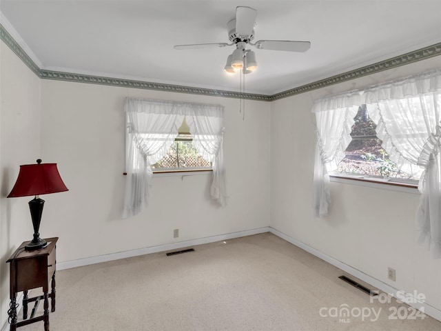 empty room with ceiling fan and carpet floors