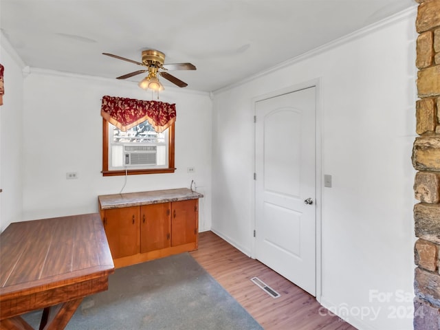 interior space with ceiling fan, light hardwood / wood-style floors, and crown molding