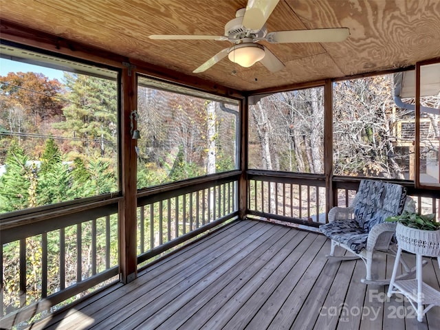 unfurnished sunroom with ceiling fan