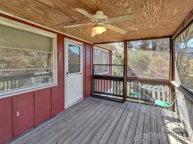 unfurnished sunroom with ceiling fan