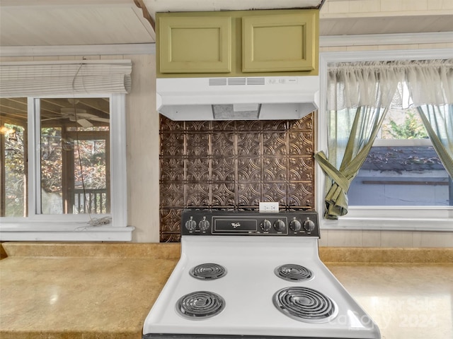 kitchen with white range oven and green cabinetry