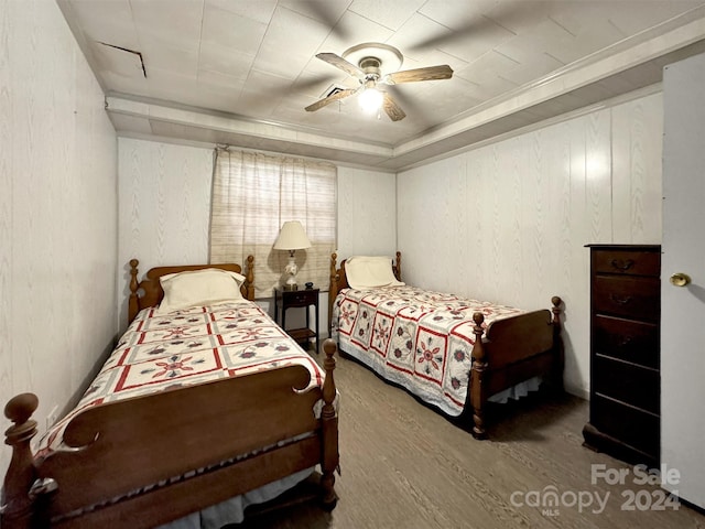 bedroom with ceiling fan and wood-type flooring