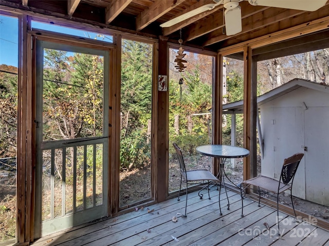 unfurnished sunroom with ceiling fan