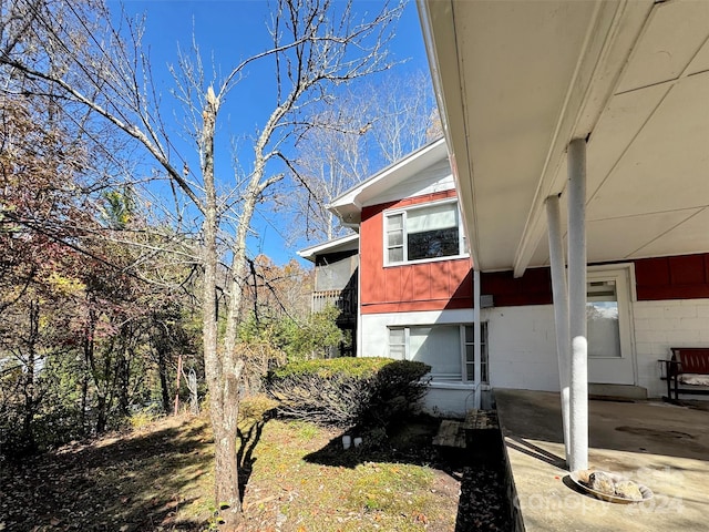 view of property exterior with a patio area