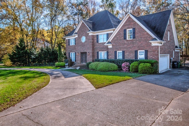 view of front facade featuring a front lawn and a garage