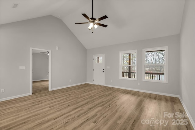 unfurnished living room with light wood-type flooring, ceiling fan, and high vaulted ceiling