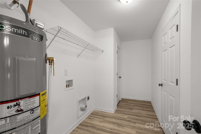 washroom with hookup for an electric dryer, washer hookup, light hardwood / wood-style flooring, and electric water heater