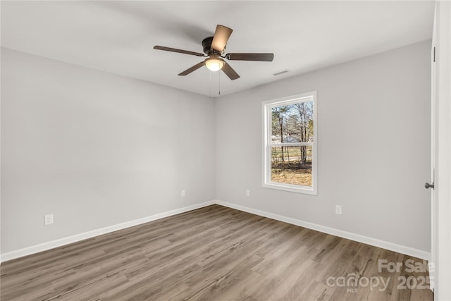 unfurnished room with hardwood / wood-style flooring and ceiling fan