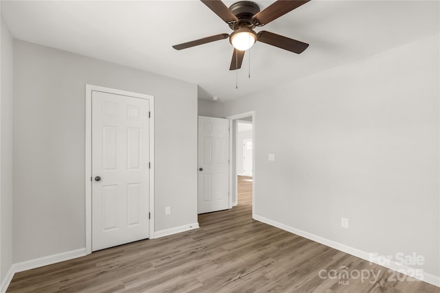 unfurnished bedroom featuring hardwood / wood-style floors and ceiling fan