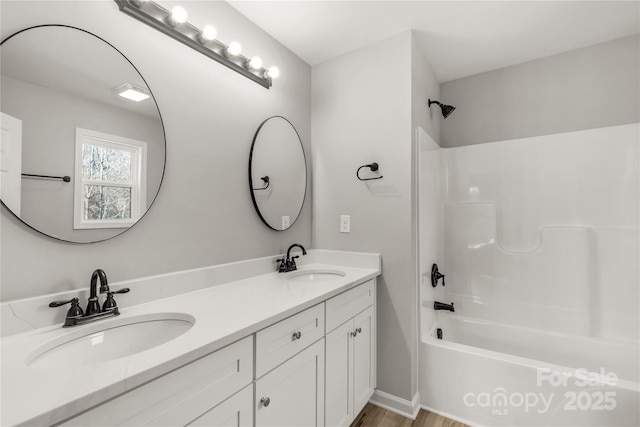 bathroom featuring bathtub / shower combination and vanity