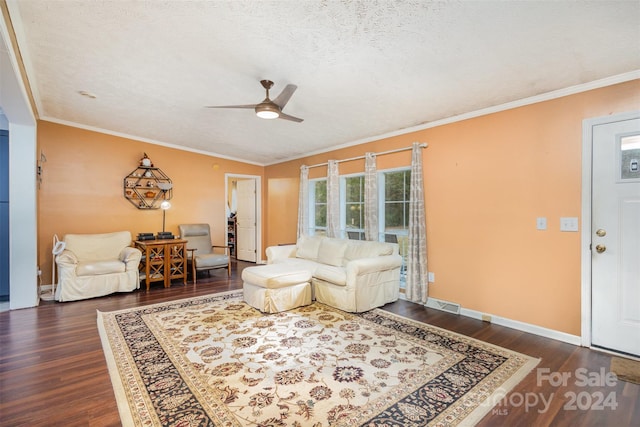 living room with dark wood-type flooring, a textured ceiling, ceiling fan, and crown molding