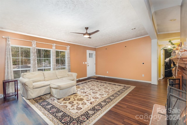 living room featuring a brick fireplace, a textured ceiling, dark hardwood / wood-style flooring, and ornamental molding