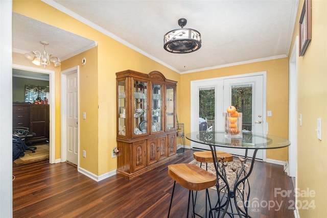 dining space with an inviting chandelier, dark hardwood / wood-style floors, and crown molding