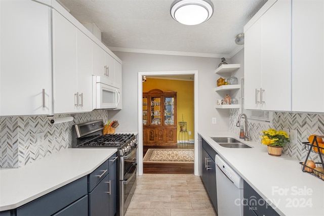 kitchen featuring white cabinetry, white appliances, sink, and blue cabinetry