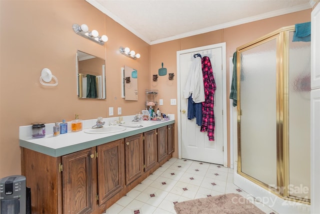 bathroom with a shower with shower door, vanity, and crown molding