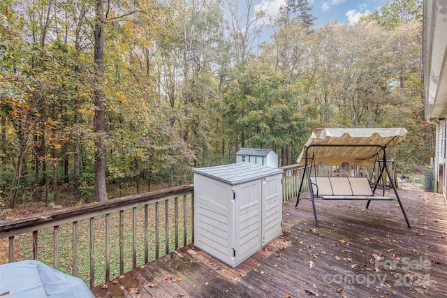 wooden deck with a storage shed