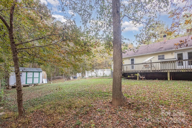 view of yard with a deck and a shed