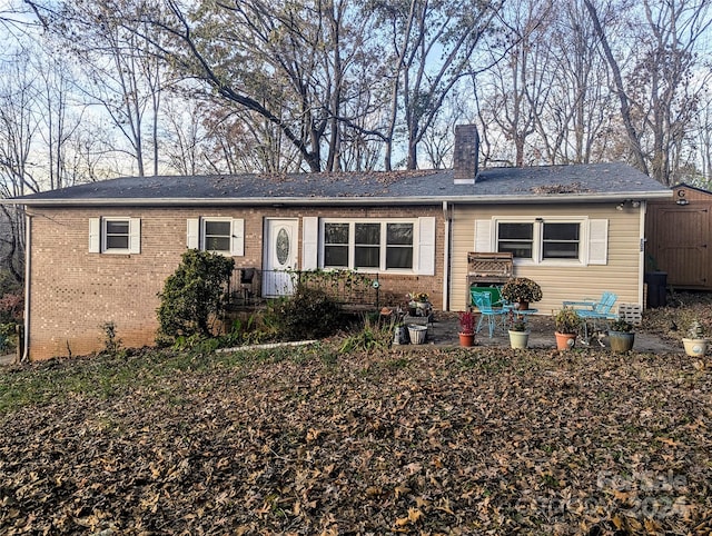 single story home with a storage shed