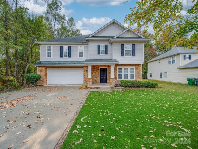 view of front of home with a garage and a front yard