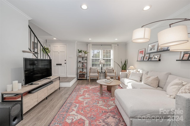 living room with hardwood / wood-style floors and crown molding