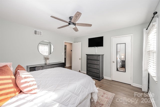 bedroom with ceiling fan and light hardwood / wood-style flooring