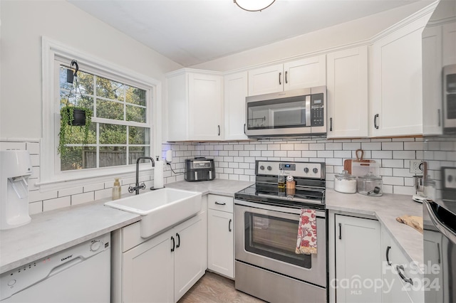 kitchen with appliances with stainless steel finishes and white cabinets