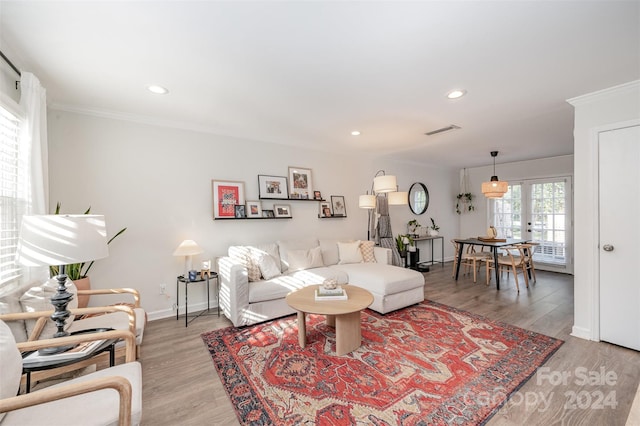 living room with french doors, hardwood / wood-style flooring, and ornamental molding