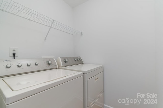 clothes washing area featuring separate washer and dryer