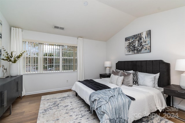 bedroom featuring dark wood-type flooring and lofted ceiling