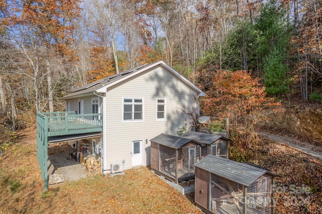 back of house with a wooden deck