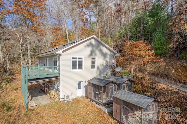 back of house with an outbuilding