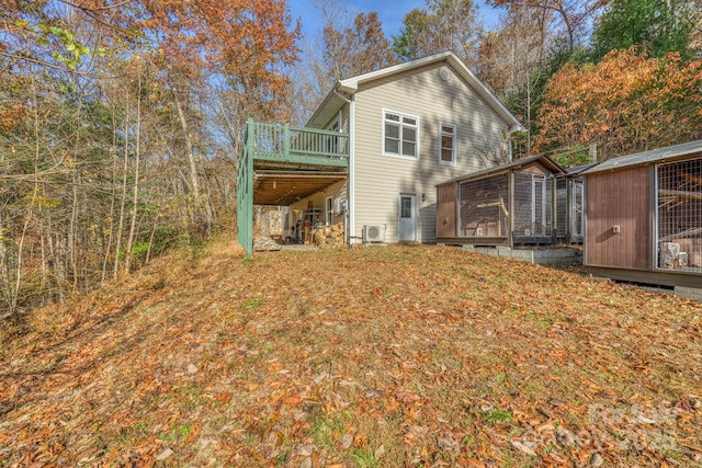 rear view of property featuring a deck