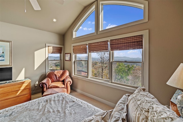 bedroom with carpet, vaulted ceiling, multiple windows, and ceiling fan